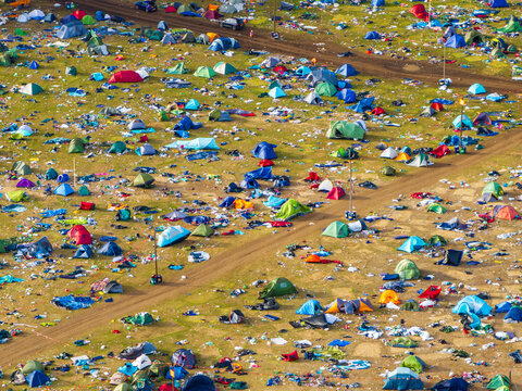 Reading, United Kingdom - 31 August 2026: Aerial view of the Reading Festival campsite, showing colorful tents scattered across the grassy field with litter left behind after the event.