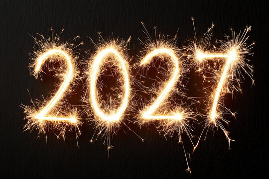 Numbers 2027 sparkle with light for the celebration of the New Year in a dark setting