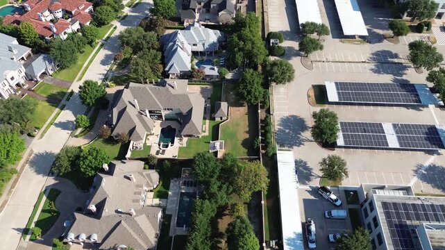 Photovoltaic canopies shelter Technology Three parking lots bordering Stonebriar Creek Estates. Commercial solar grids meet private backyard swimming pools off Internet Boulevard, Frisco, Texas