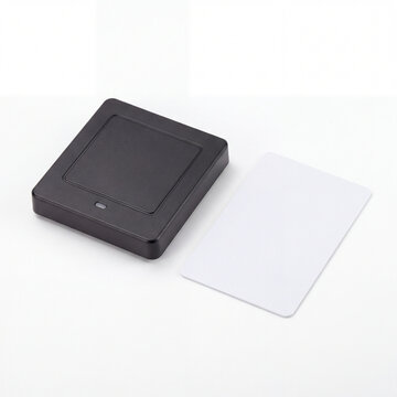 Access Card Reader and Card: A black electronic card reader device sits next to a blank white access card, symbolizing security and entry control.