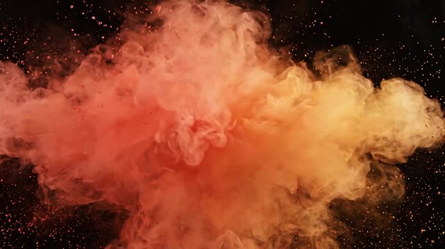 Red and orange powder explosion bursting in slow motion on black background
