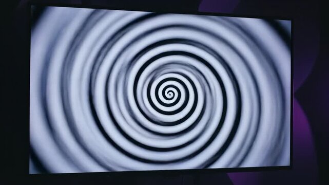 Mesmerizing black and white spiral animation creating an optical illusion of a vortex, suggesting hypnosis or mind control.