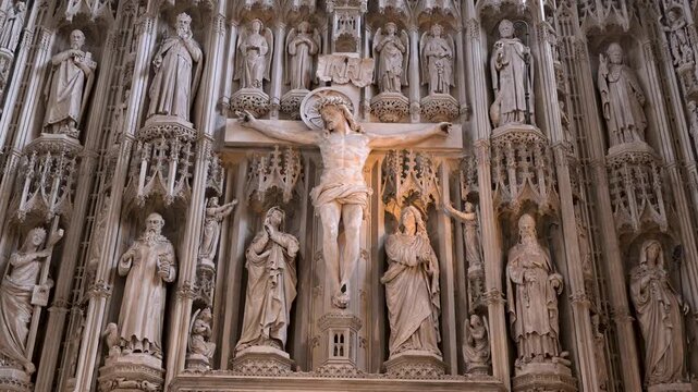 Crucified Jesus and surrounding saints carved into the High Altar Reredos slowly fill the frame in this historic church interior shot.