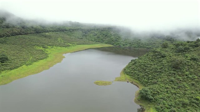 4K drone aerial view of Yala Provincial Park in Jujuy, Argentina. Misty mountain lakes surrounded by lush Yungas forests and dense green vegetation in a spectacular Andean landscape.