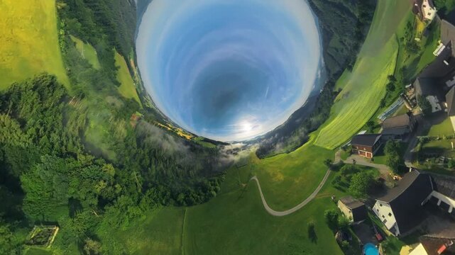 Creative drone footage of the M&uuml;hlviertel in Upper Austria transitioning from a tiny planet view into the opposite inverted planet effect, transforming the green countryside dynamically.