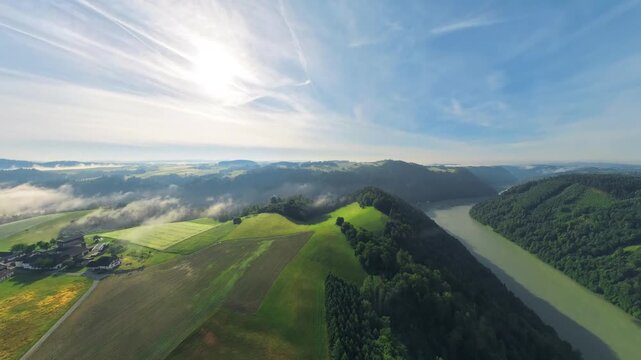 Drone footage over the M&uuml;hlviertel in Upper Austria at sunrise. During the flight, the camera smoothly rotates toward the scenic Danube Valley, revealing forests and rolling countryside.