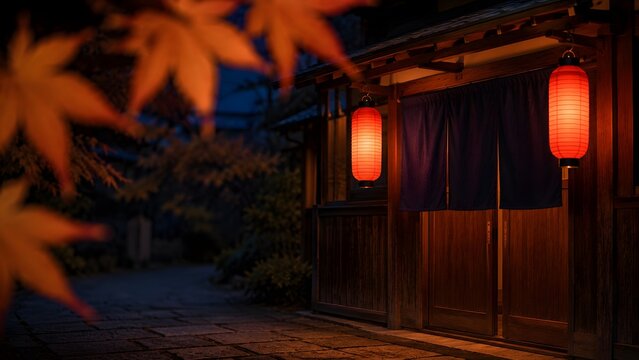 紅葉越しに見る秋の夜の居酒屋の赤ちょうちんと石畳の路地