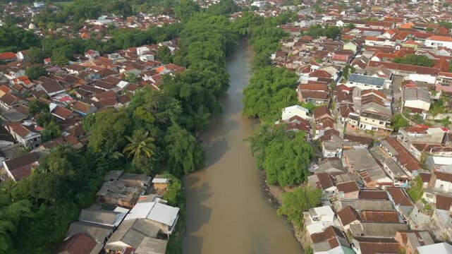 River Runs Through Downtown Jember City East Java Indonesia Drone Track Upstream 4K 60FPS