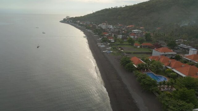 Black Sand Amed Beach Morning Sunrise Bali Indonesia Drone Track Along Shore 4K 60FPS