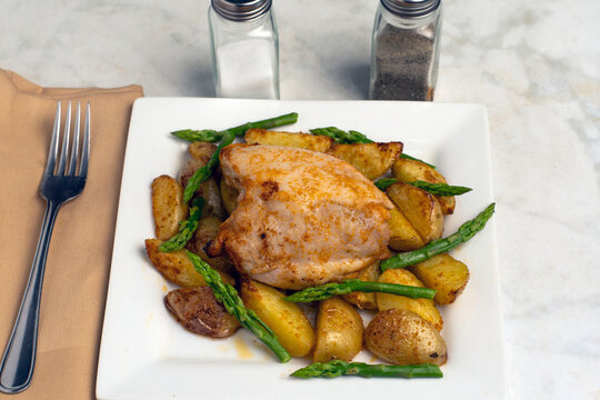 chicken thigh  with  potato wedges and  asparagus