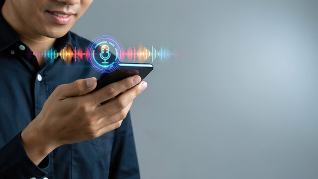 A man holding a smartphone with an interactive voice recognition interface on a gray background with smartphone with smartphone