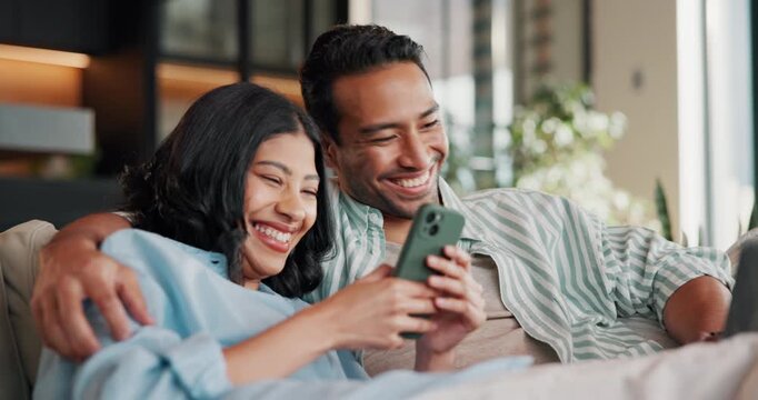 Happy, talking and couple on sofa with phone, internet and option on ecommerce website on weekend. Relax, home and man with woman on tech for connection, bonding and conversation for online shopping
