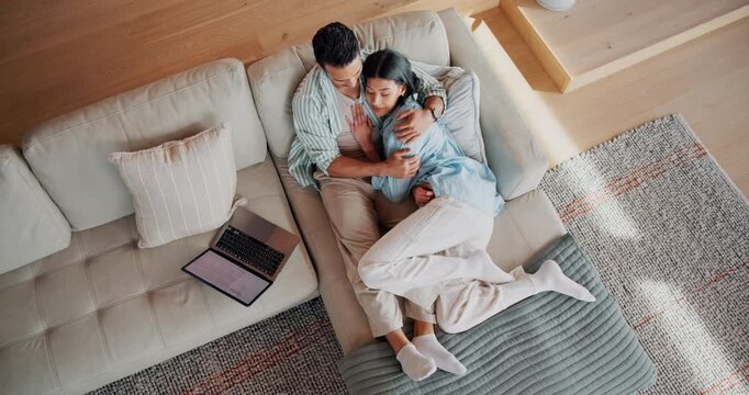 Laptop, hug and people on sofa in house with bonding, connection and affection in marriage together. Couple, computer and woman embracing man in living room for support in relationship from above