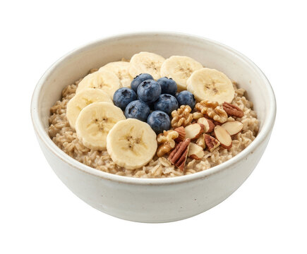Healthy breakfast oatmeal bowl topped with sliced fresh banana blueberries and nuts