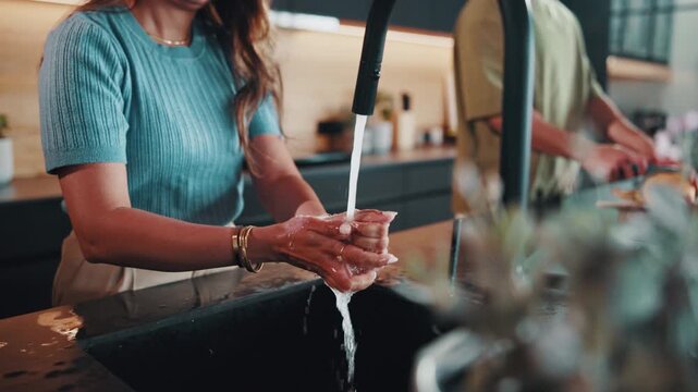 Woman, washing hands and couple in kitchen for cleaning, good hygiene practice and dirt removal. People, faucet and rinsing in home for wellness, bacteria prevention and dermatology with self care