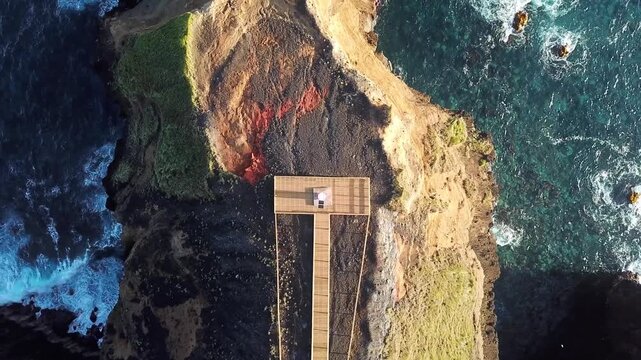 Forward drone flight traces a basalt promontory to its tip above the Atlantic, Fenais da Ajuda, Sao Miguel, Azores