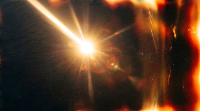 Intense sunbeam flare and ambient film burn on a minimalist dark surface