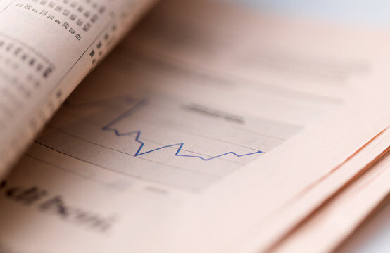 Financial Newspaper Pages with Stock Market Graph
