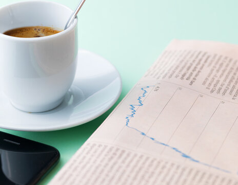 Fresh Espresso Cup Smartphone and Financial Newspaper