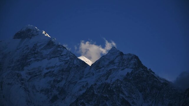 Close time lapse of cloud moving over the Nilgiri summit ridge at sunset, Upper Mustang, Nepal