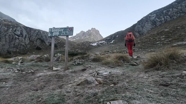 Solo male hiker on a mountain trail climbing up towards Bobotov Kuk in Durmitor National Park in Montenegro