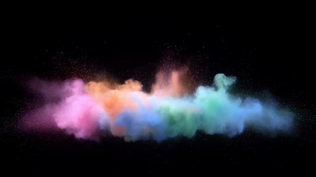 Multicolored powder cloud bursts and expands across a black background in a vivid abstract display