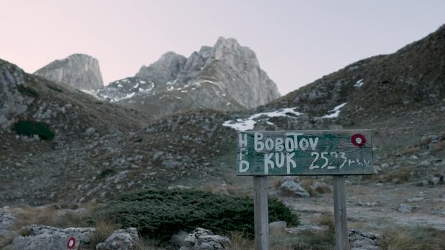 Signpost at the start of a mountain trail climbing up towards Bobotov Kuk in Durmitor National Park in Montenegro