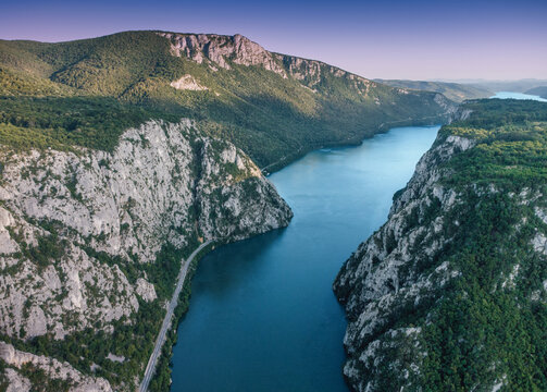 Danube river flowing between steep forested cliffs, creating the stunning Iron Gates gorge in Djerdap Park