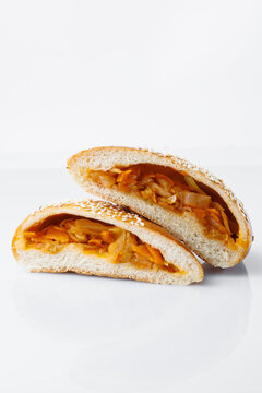 Savory Baked Bun with Vegetable Filling on White Background