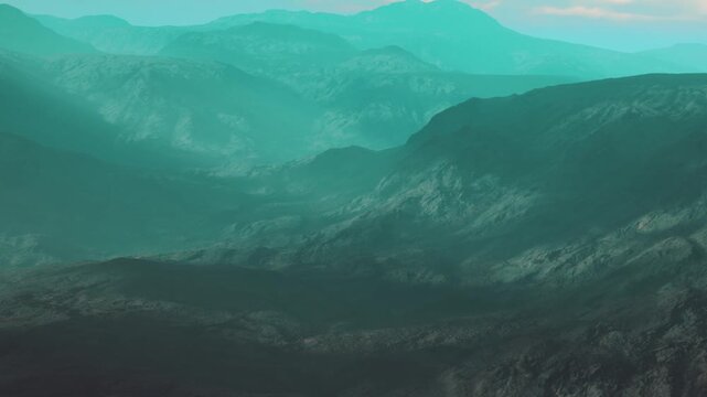 A vast mountain landscape shows large hills and peaks covered in fog. The scene is bathed in greenish tones and highlights the natural beauty of the surroundings.