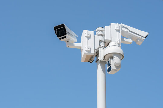 Combined highway surveillance system with fixed CCTV cameras and PTZ camera mounted on roadside pole in Greece, representing traffic monitoring, safety and transportation infrastructure, copy space