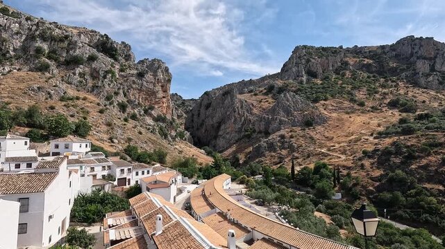 Tiled rooftops of Zuheros below the rugged crags of the Ca&Atilde;&plusmn;on del Rio Bailon, Cordoba, Andalucia, Spain