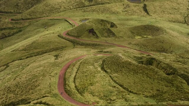 View from Pico da Esperan&radic;&szlig;a A red dirt road winds between grassed cinder cones on the high central ridge, Sao Jorge, Azores, Portugal