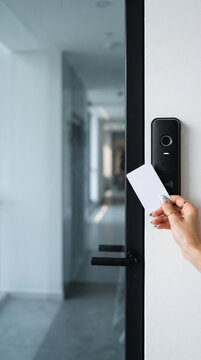Hand holding access card to RFID reader on door, symbolizing security, entry, and technology, ideal for access control concepts