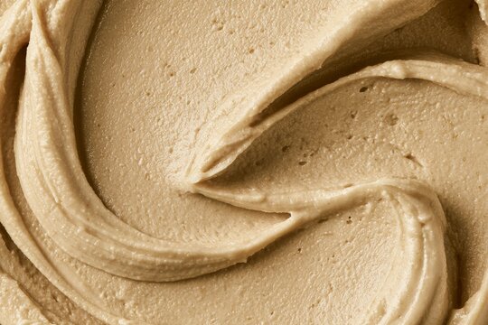 Creamy texture of nut butter in close up view showing smoothness and richness in detail
