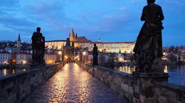 Evening view of charles bridge and prague castle with waving czech flag, iconic historic landmark at twilight