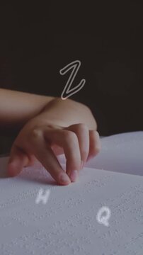 A girl is reading a braille book in a classroom