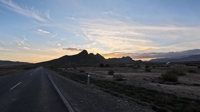 Desert road toward mountains at sunset, Ziz Canyon, Draa-Tafilalet, Morocco