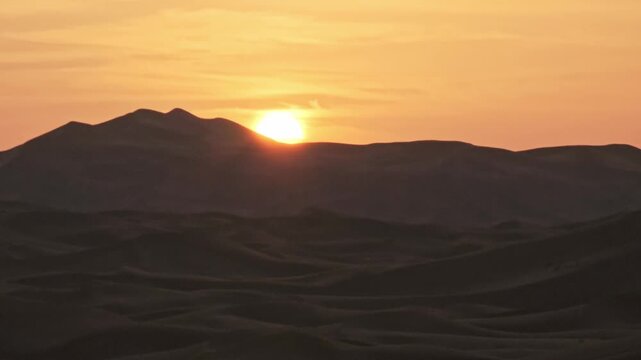 Sun setting behind the dune ridges of Erg Chebbi near Merzouga, Draa-Tafilalet, Morocco