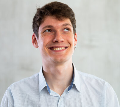 Portrait of young smiling guy in studio