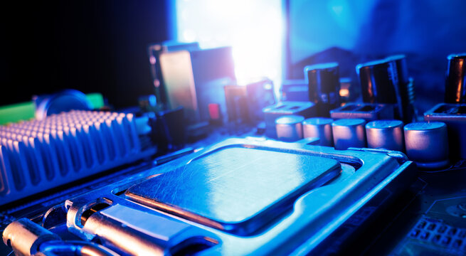 Closeup motherboard cpu socket with metal processor and blue neon lighting for technology background and hardware design