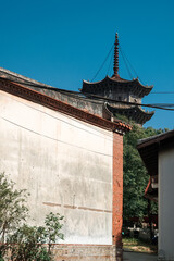 The stone tower of Kaiyuan Temple in Quanzhou contrasts with the old red brick wall © Steve
