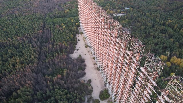 Aerial view of the massive Duga radar array rising above the dense forest in the exclusion zone of Ivankivs'kyi district, Kyiv Oblast, Ukraine.