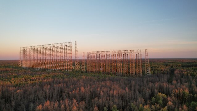 Aerial view of the massive Duga radar array, a historic Soviet over-the-horizon radar system, rising above the dense forest in the exclusion zone of Ivankivs'kyi district, Kyiv Oblast, Ukraine.