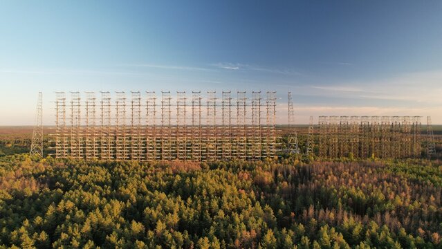 Aerial view of the massive Duga radar array rising above the dense forest canopy in Ivankivs'kyi district, Kyiv Oblast, Ukraine.