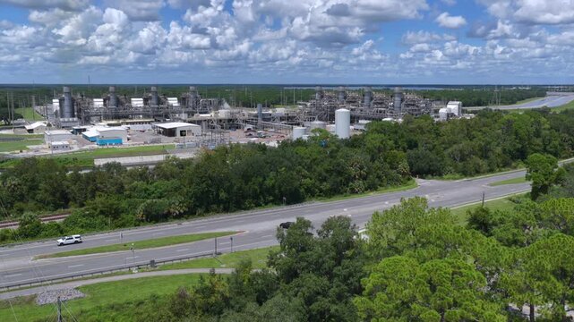 Aerial view of FPL Sanford Power Plant with industrial infrastructure surrounded by lush green vegetation and a nearby highway in DeBary, Florida, United States.