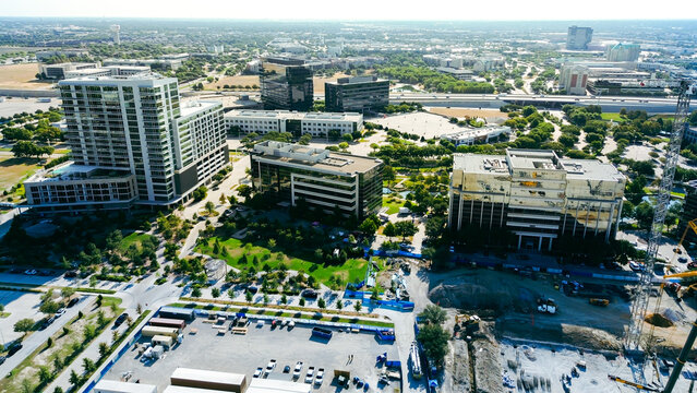 Active construction zones border sleek residential high-rises along Internet Boulevard. Dynamic mixed-use commercial developments reshape master-planned corporate sectors, Frisco, Texas