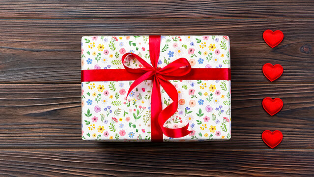 gift box with red ribbon on wooden background,culture,celebration