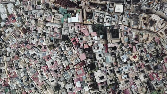 Aerial view of the dense historic medina rooftops and narrow alleyways of the ancient city of Fes, Fez-Meknes, Morocco.
