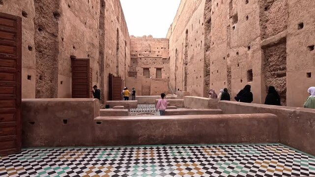 unken courtyard within the ruined walls of El Badi Palace, Marrakech, Morocco, checkerboard zellij underfoot in flat white ligh